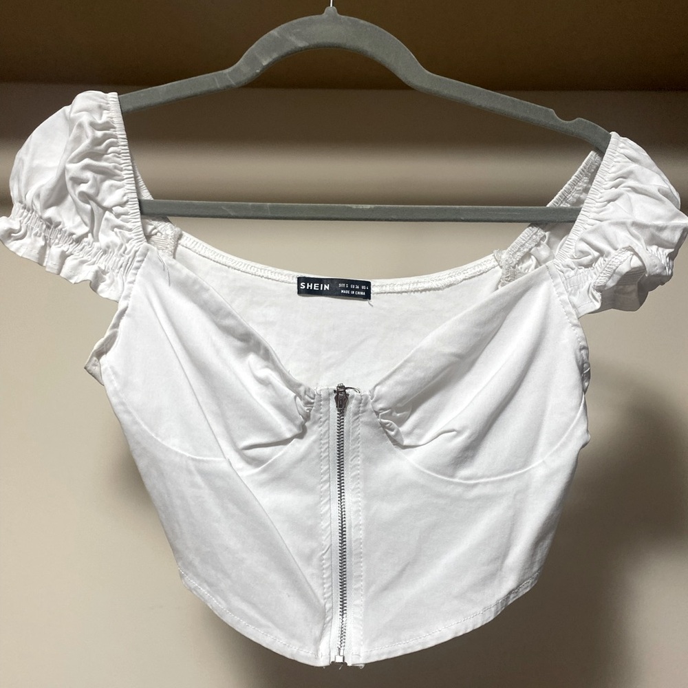 SHEIN white cropped zip up corset top with puffy sleeves.